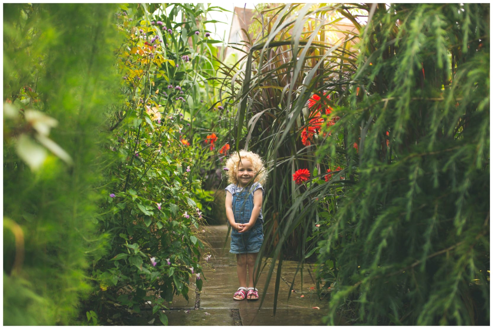 A child standing in the Exotic garden at Great Dixter while taking part in a family activity